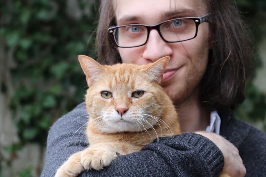 Victor V. Gurbo poses with his cat, Pumpkin.