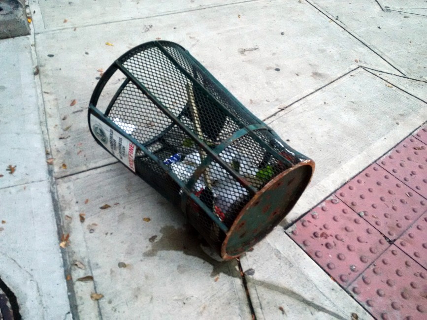 A fallen trash can on a street corner in Gowanus.