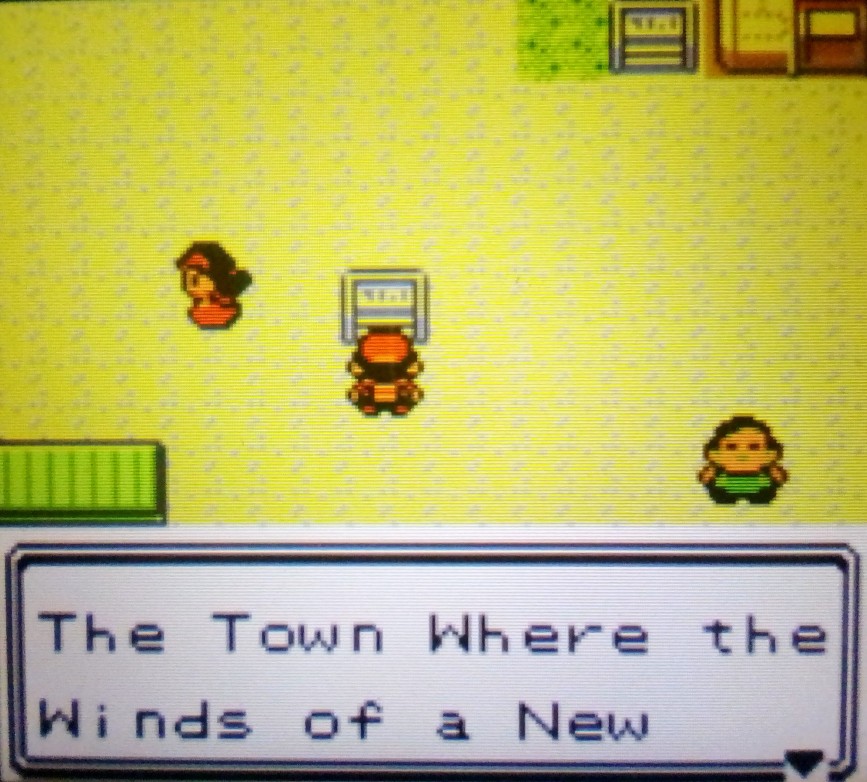 Player reading the town slogan for "New Bark Town" in Pokémon Crystal:  "The Town Where the Winds of a New"