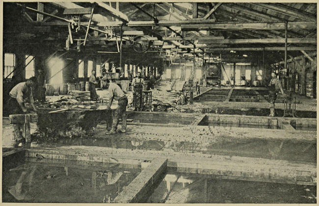 Photograph of tanners hard at work - pictured in "Manual of Shoemaking and Leather and Rubber Products" (1912)
