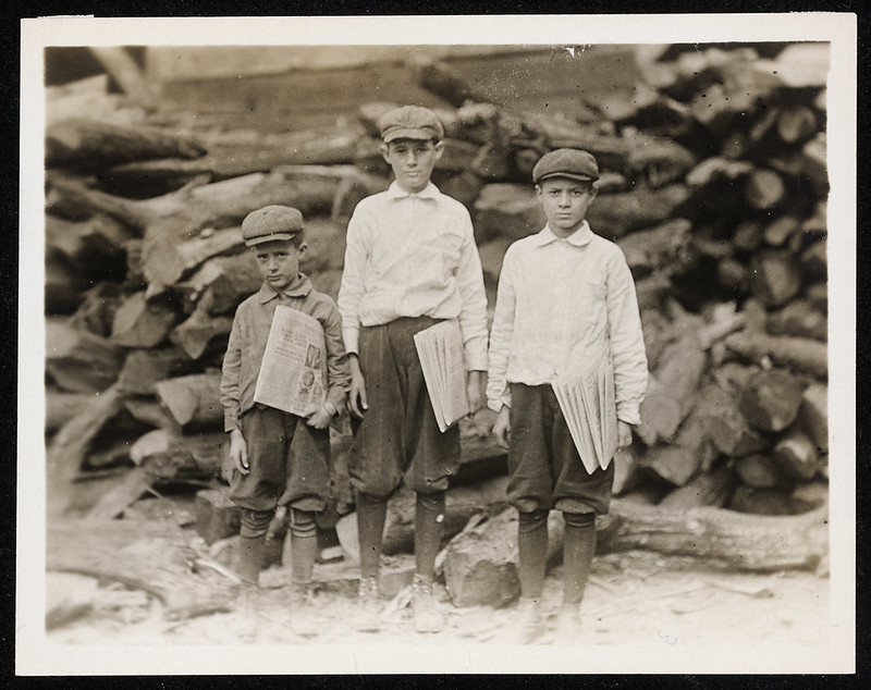Photograph of three young paperboys posing with their newspapers in Tampa, Florida, in 1913