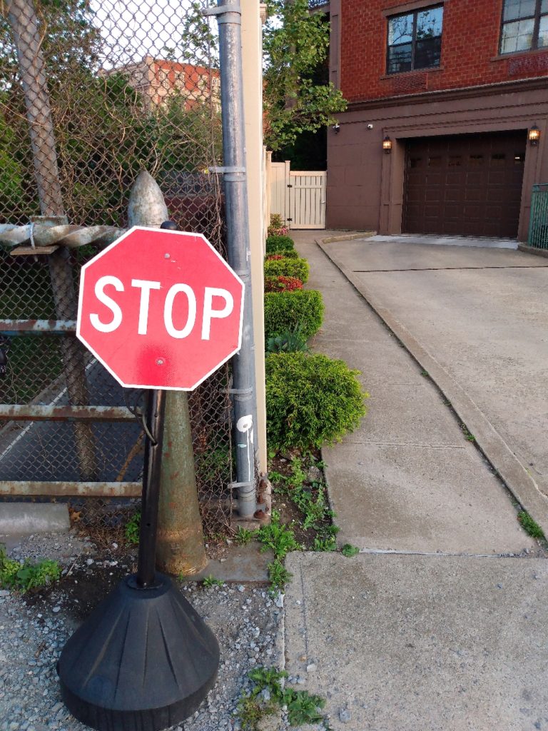 A miniature stop sign guarding a driveway in Carroll Gardens, Brooklyn.