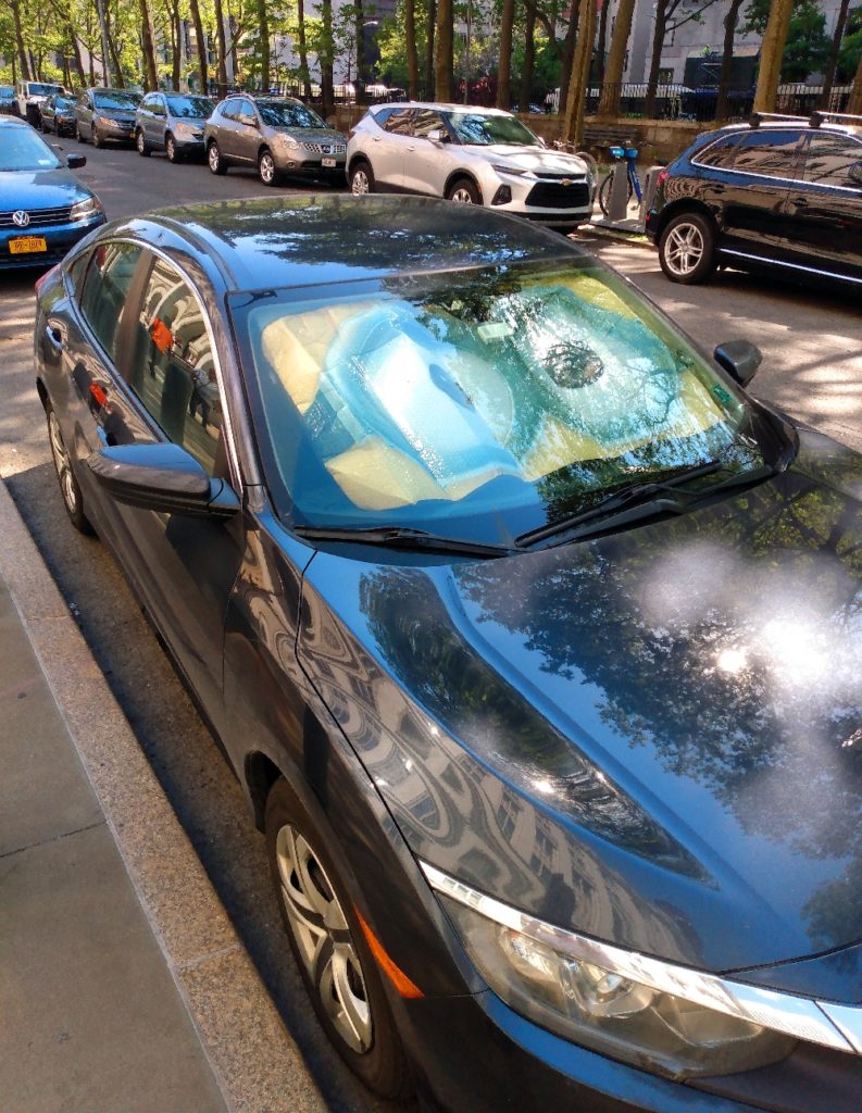 Photograph of a car with a Minion windshield sunshade in Downtown Brooklyn NY.