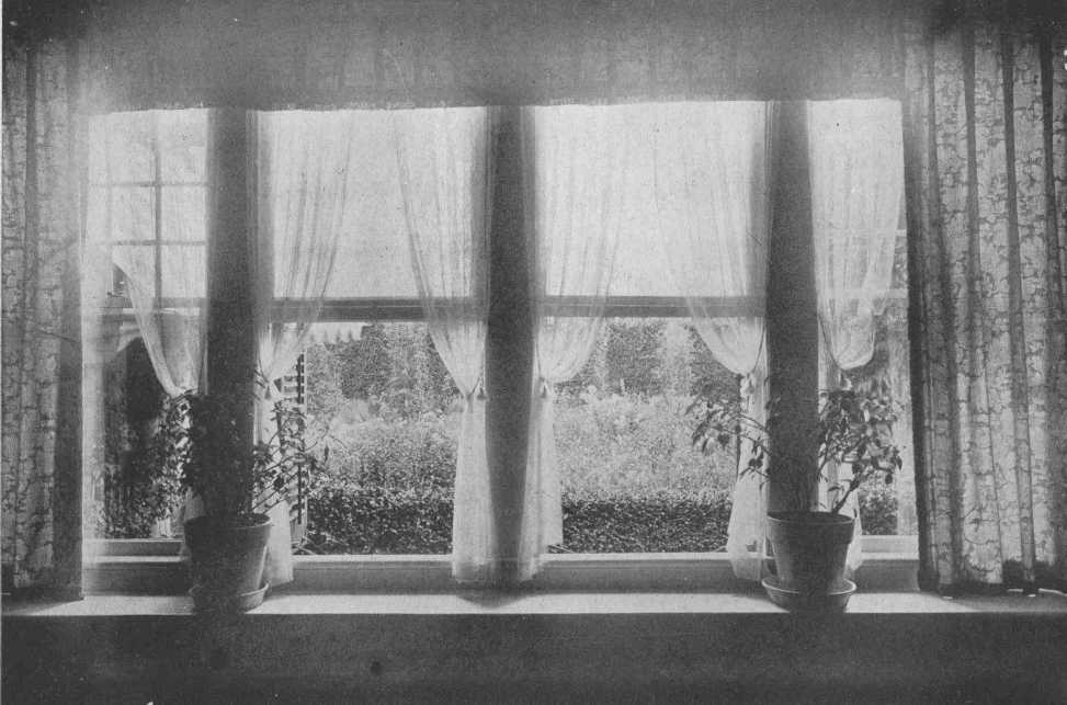 Pictures of windows with white curtains looking out onto a garden from "Furnishing the Room of Good Taste" (1920).