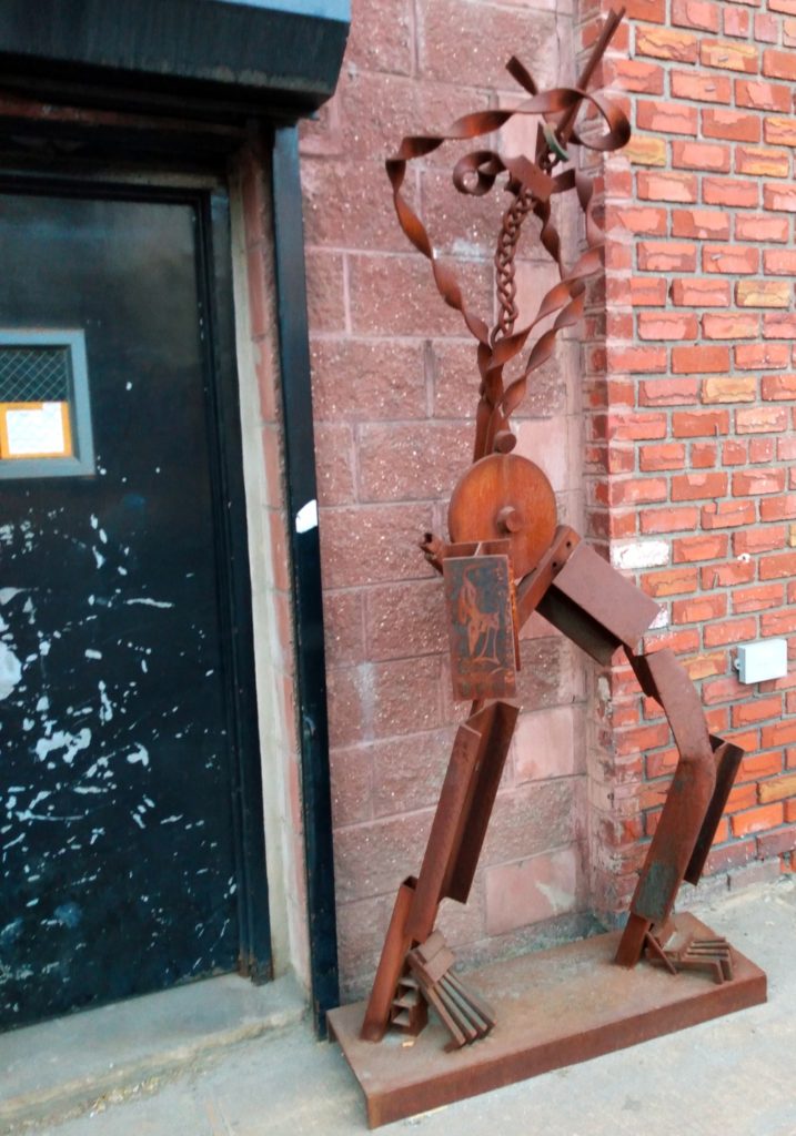 A strange statute made out of scrap metal and spare part seen in Gowanus, Brooklyn.