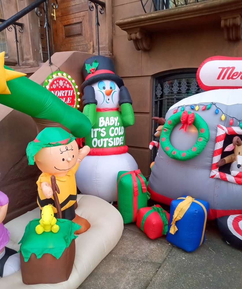 An inflatable Woodstock, Charlie Brown, Frosty the Snowman, and Santa Claus van seen in Clinton Hill, Brooklyn.