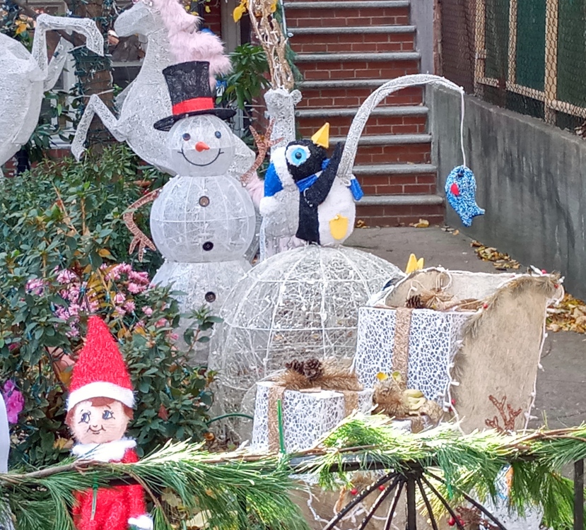 An ice-fishing penguin on an igloo as part of a Christmas display on a lawn in Gowanus.
