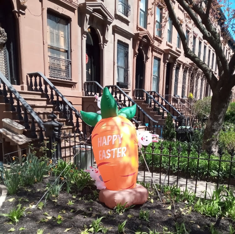 N.A. Ferrell's photograph of an inflatable carrot and bunny Easter decoration in Boerum Hill, Brooklyn.