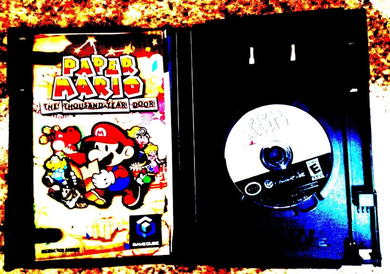 A copy of Paper Mario: The Thousand-Year Door in its original box with the instruction booklet.