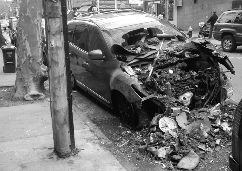 Black and white photo of an unfortunate car that was destroyed by a fallen tree branch in Carroll Gardens, Brooklyn, in 2018.