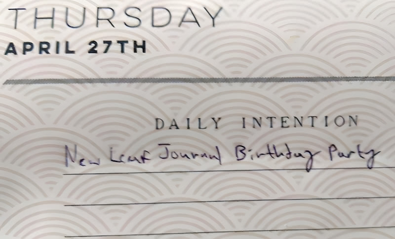 Photograph of April 27 in the IKIGAI 2023 full color calendar by Willow Creek Press with "New Leaf Journal Birthday Party" written as the daily intention.