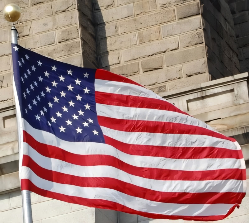 Photograph of an American Flag against the backdrop of the Brooklyn Bridge. N.A. Ferrell took this photo on March 26, 2007.