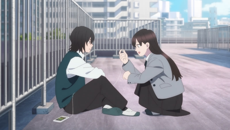 Shin and Ema sitting on a school roof in a high school flashback in A Sign of Affection. Shin is sitting on the ground with his back to the fence while Ema is kneeling and smiling while holding one of Shin's earbuds.