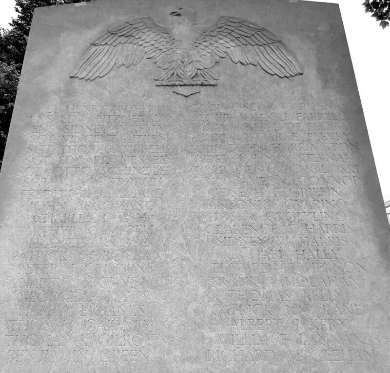 Front of the McLaughlin Park World I Memorial in Downtown Brooklyn. The following names are engraved below an eagle in stone: LT. HENRY J. DUFF --- CORP. OSCAR GARDENAS / ENS. EDW. FITZGERALD --- COPR. JOHN J. FARRELL / ENS. SIDNEY J. KELLY --- CORP. RALPH DE FLORA / SGT. VINCENT AITKEN --- CORP. OSCAR E. FLEURY / SGT. THOS. CAMPBELL --- CORP. TOHS. HARRINGTON / SGT. EDWARD MESSER --- CORP. JOHN. A KIERNAN / SGT. OTTO SCHINDLER --- CORP. GEO. MICHOLOSKI / SGT. WM. V. STORCH --- CORP. JAMES OCONNOR / FREDERICK I. ALLARD --- JOSEPH P. GRIFFIN / JOHN ARCOMANO --- ANTONIO GUARINO / CHARLES I. ASH --- JOS. A. GUGLULINO / ARTHUR CAMPBELL --- CLARENCE F. HARRIS / FRANCIS J. CARR --- SIDNEY W. HARRIS / PATRICK CORCORAN --- MICHAEL HALEY / PETER J. CRIMMINS --- EDWARD H. HERNON / HARRY M. GUNDY --- FRANK J. HOLAHAN / GEORGE P. DAVIS --- THOMAS KELLY / HARRY EUBANKS --- PATRICK JOS. KANE / THOS. M. GAFFNEY --- ALBERT J. KERN / THOMAS K. GILROY --- WILLIM E. LANNAN / BENJAMIN GREEN --- RICHARD MCGEEHAN / 