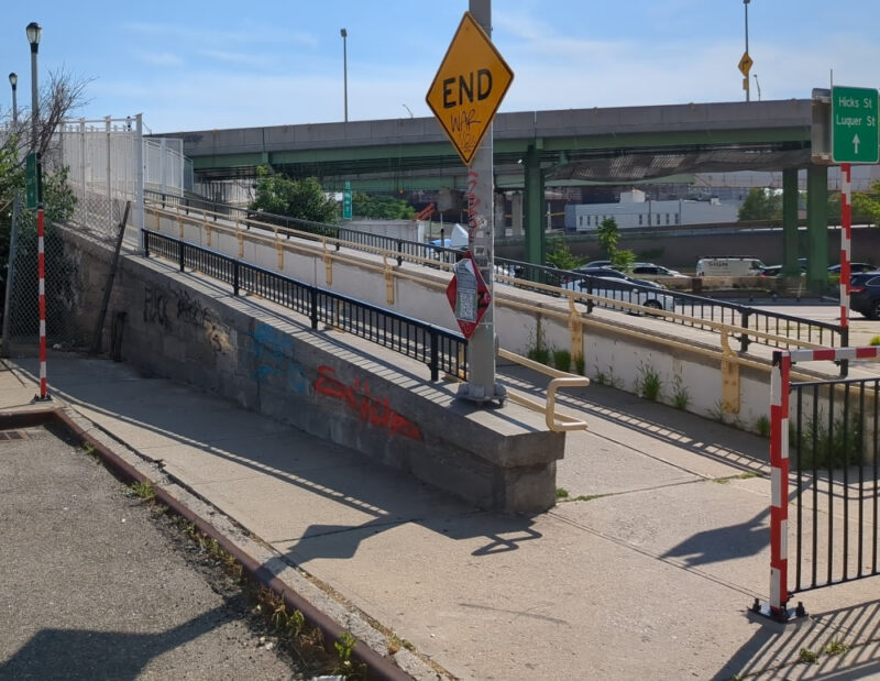 Entrance to the Hamilton Avenue Footbridge from Coles Street in Carroll Gardens. There is an END sign in front of the opening to the walkway, but the sign is for cars.