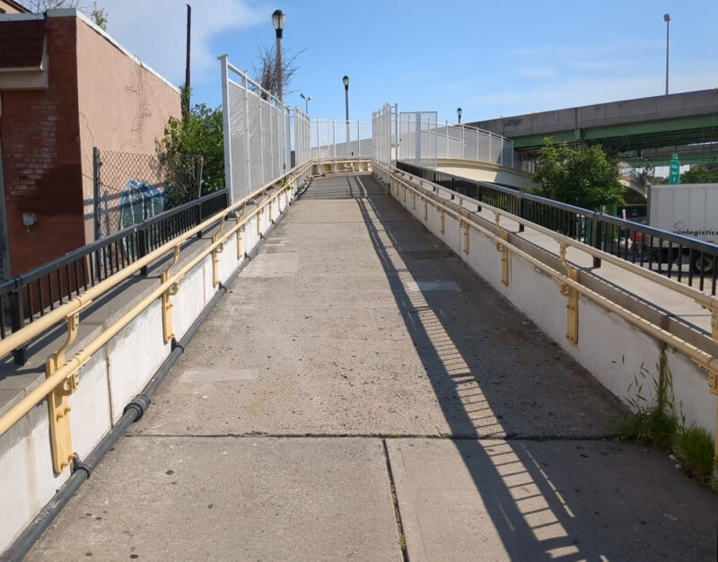 Opening ramp of the Hamilton Avenue Footbridge. It goes straight before turning right toward the Gowanus Expressway in the distance.