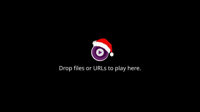 Empty mpv media player window with black background and mpv logo with Santa hat in the center.