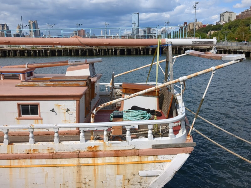 Back of the Victory Chimes schooner with Brooklyn Bridge Park's Pier 5 in the background.